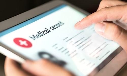 A person accessing medical records on a tablet.