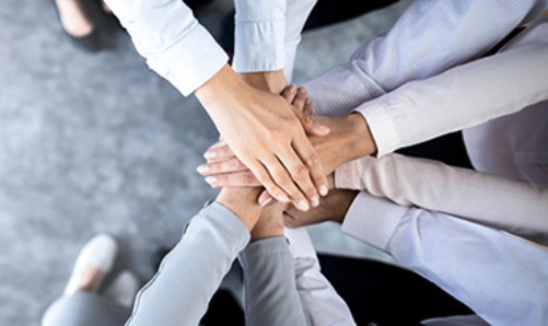 Group of people stacking hands